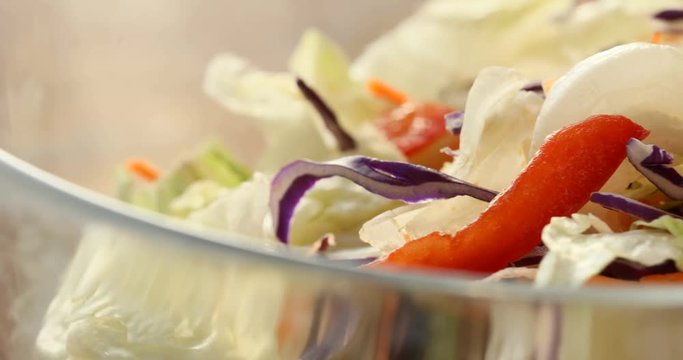 Healthy eating. Bowl of salad mix with vegetables and greens on wooden table close-up.