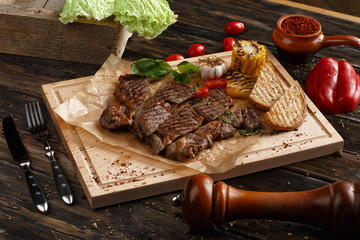Club Beef steak with pepper sauce and Grilled vegetables on cutting board on wooden background