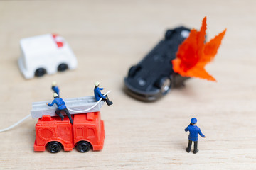 Miniature people : Firefighters at a car accident  , Cars on fire blow up