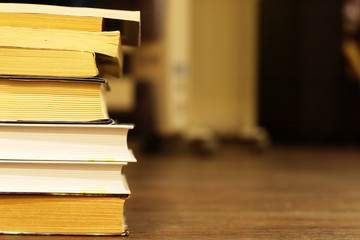 Books on Bookshelf. Old Books with Yellow Pages Stacked in Pile against Blurred Background with Copy Space