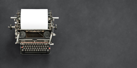 Vintage typewriter with blank sheet of paper retro technology