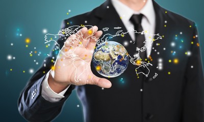 Close up of businessman holding digital globe in palms
