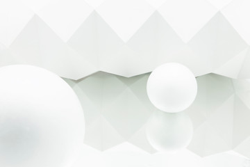 white origami background reflected in mirror with two white spheres of different sizes