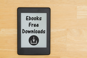 An e-reader on a wood desk with text ebooks Free Downloads