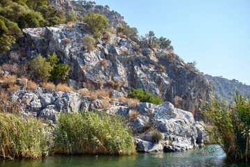 Fototapeta premium Landscape photography. Rocky bank of the river on the Mediterranean coast.