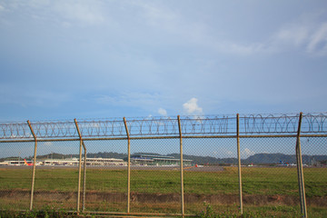 Metal fence wire, War and sky in the background in Phuket Thailand