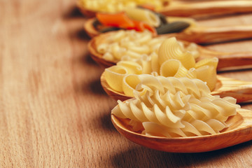 Various pasta on spoons