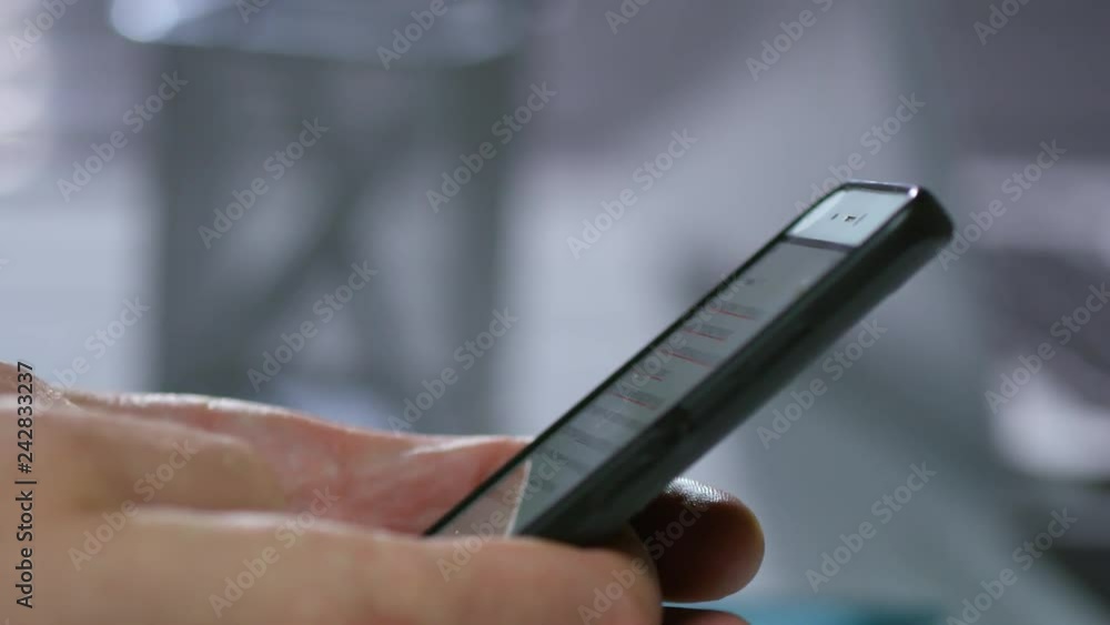 Poster extreme close up tracking shot of hands of unrecognizable businessman browsing internet using smartp