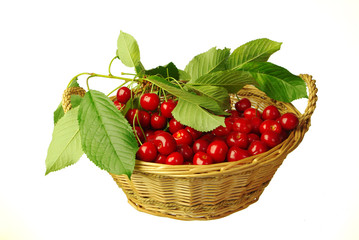 Sweet cherries with leaves in a basket on a white background