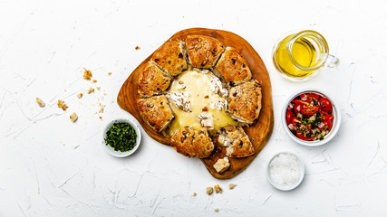 camembert baked in the oven with herb bread served