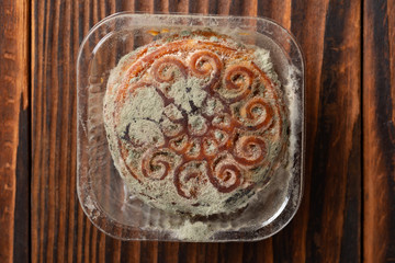 moldy moon cake on wood background