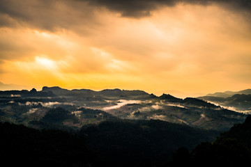 Obraz premium silhouette mountain in morning with Sunshine over the land