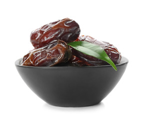 Bowl with sweet dried dates on white background