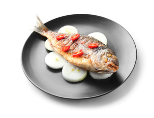 Plate with grilled dorado fish and vegetables on white background