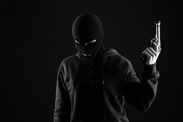 Bandit with gun on dark background