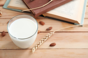Glass of fresh milk on wooden table