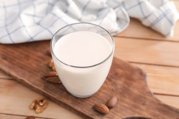 Glass of fresh milk on wooden table