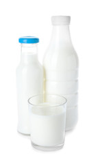 Bottles and glass of fresh milk on white background