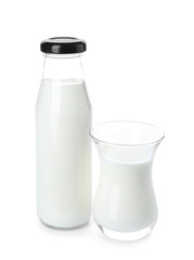 Bottle and glass of fresh milk on white background