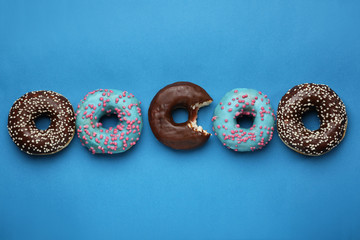 Sweet tasty donuts on color background