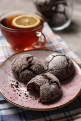 Plate with tasty chocolate cookies on table