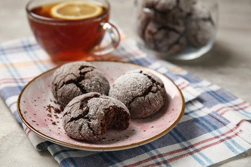 Plate with tasty chocolate cookies on table
