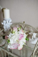 wedding bouquet of the bride on a glass table, white and pink peonies