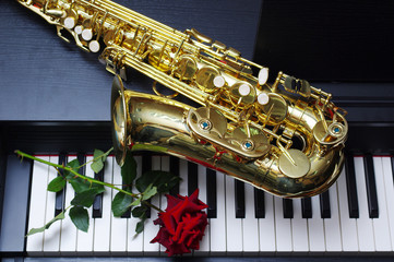 Saxophone, red rose and keyboard