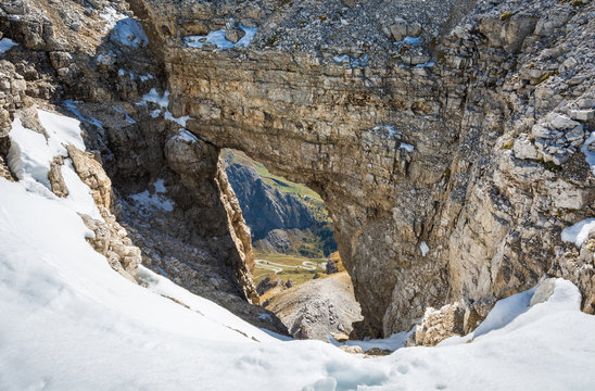 Fototapeta a rock windows from the Sass Pordoi plateau in Dolomites, Trentino Alto Adige, northern Italy, Europe. View of the pass Pordoi with serpentines leading to the Sella Mountains group
