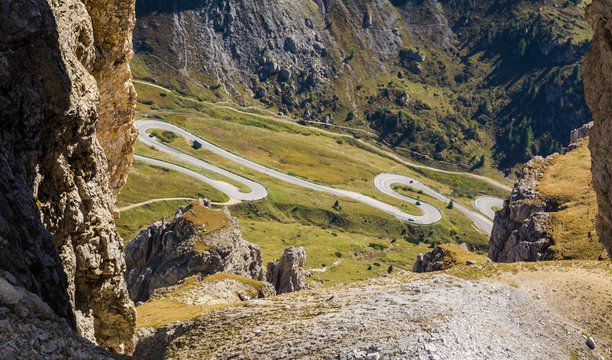 Fototapeta a rock windows from the Sass Pordoi plateau in Dolomites, Trentino Alto Adige, northern Italy, Europe. View of the pass Pordoi with serpentines leading to the Sella Mountains group