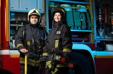 Image of happy fireman and woman near fire truck