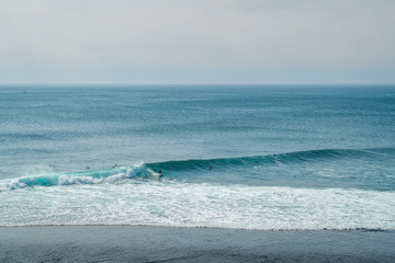 Sea Aerial View of Teal Surfing Ocean. Top View of Big Waves. Aerial View of Waves Flying by Drone. Aerial Ocean Beach on Early Morning. Surfing & Surfers on the Bali Beach Spot. Blue Ocean Background