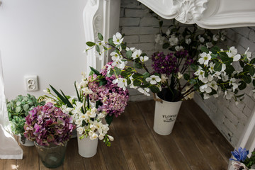 Fototapeta premium beautiful flowers in vases on the floor