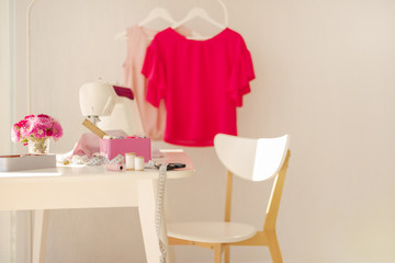 Workplace for sewing and needlework in a bright room with white furniture.