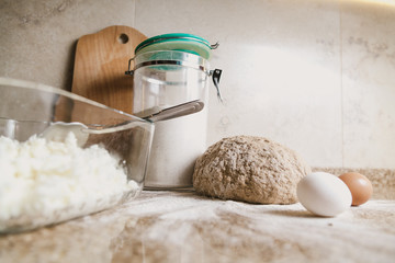 Kitchen still life. Dough, flour and eggs are on tabletop