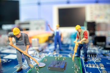 Miniature repair man mainboard, Miniature  worker team try to repair cpu on mainboard