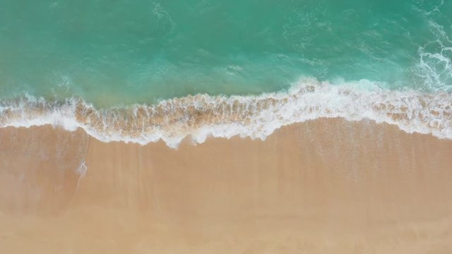 Aerial View Directly Above Gentle Ocean Waves Breaking onto Sand at Oahu, Hawaii