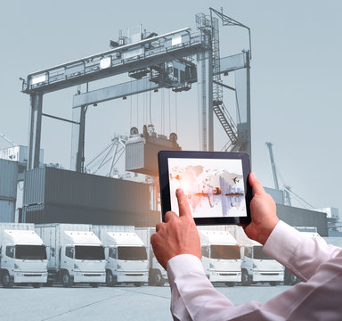 transportation import export concept,Man hand holding cell phone or tablet  automate wireless for control drlivery shipment