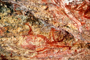 Ancient aboriginal painting art representing humans on huge rock stone in Kakadu park, northern territory, Australia.