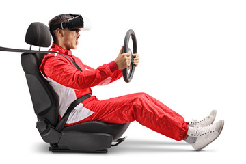 Excited male racer in a car wheel holding a steering and wearing VR headset