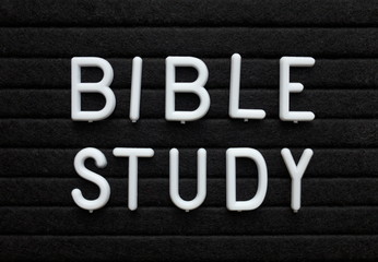 The words Bible Study in white plastic letters on a black letter board as a reminder