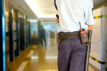 Security guards control the indoor entrance door