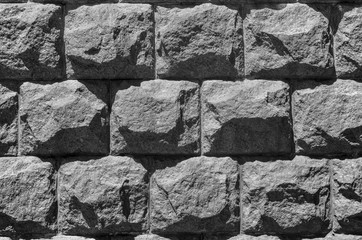 Stone grey cladding on an urban building as the background for 3d graphic. Wall from rough slab. Natural texture of rock. Textured vintage modern facade, closeup front view