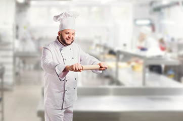 Funny cheerful chef in white uniform on a background.
