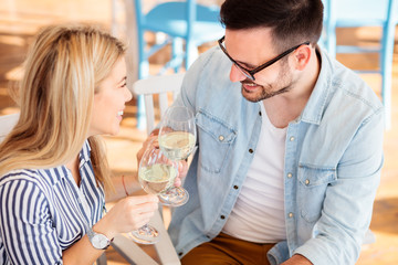 Happy young couple making a toast to celebrate their love. Enjoying Valentine's day in a restaurant