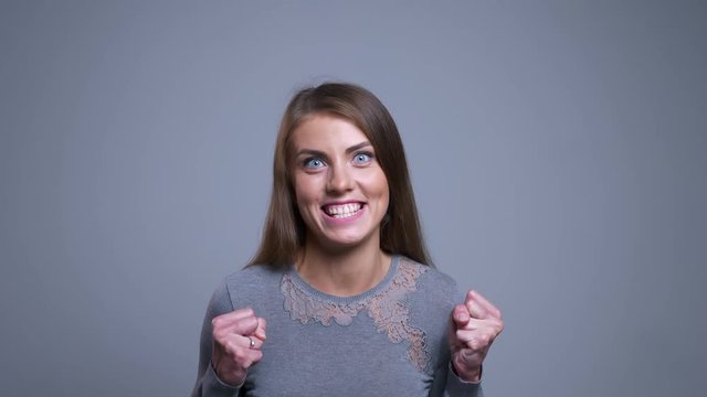 Closeup portrait of beautiful caucasian female getting excited because of success good news happily screaming