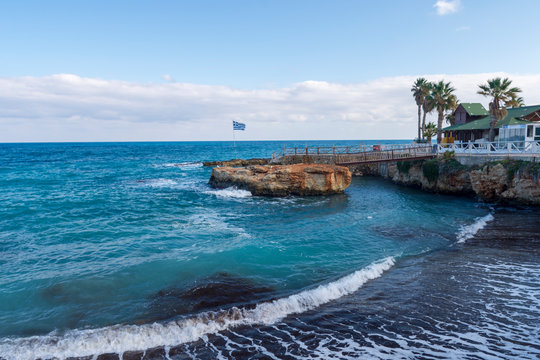 Little bay with a sand beach near the village (Limenas Chersonisou) Crete Island Greece.