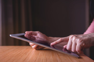 Modern Person Using Digital Tablet on Wooden Table, Sideview and Selective Focus