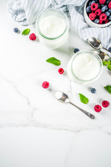 Two portion of yogurt with berries