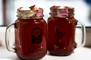 Mugs with chocolate and  ginger cookies on a wood desk with different lights